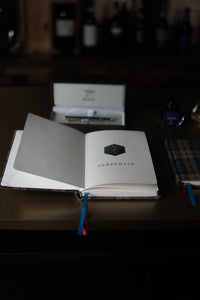 A5 Dotted Notebook — open, dot grid pages and cognac ribbon